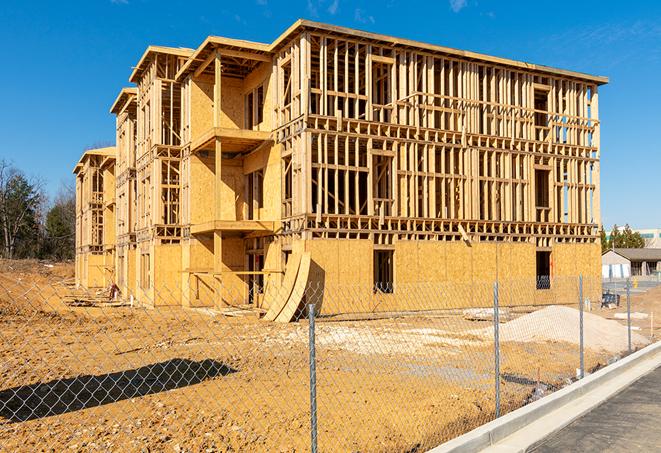 a close-up of temporary chain link fences enclosing a construction site, signaling progress in the project's development in Whitesville, KY